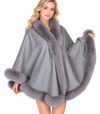 Model wearing the CA50 light grey cashmere cape with fox fur trim
